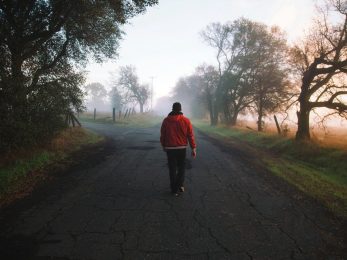 man walking on road at daytime