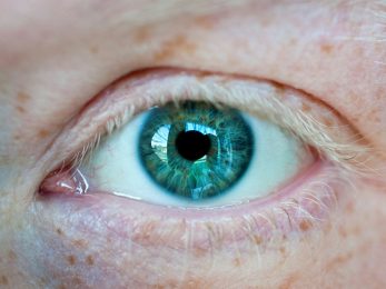 persons blue eye with green eyes