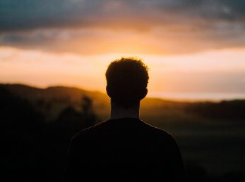 silhouette of a man facing the sunset