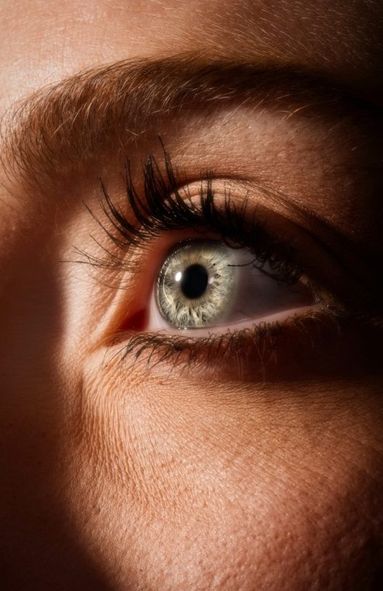 persons blue eyes in close up photography