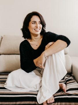 woman in black long sleeve shirt sitting on white couch