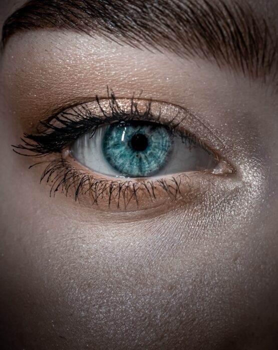 persons blue eyes in close up photography